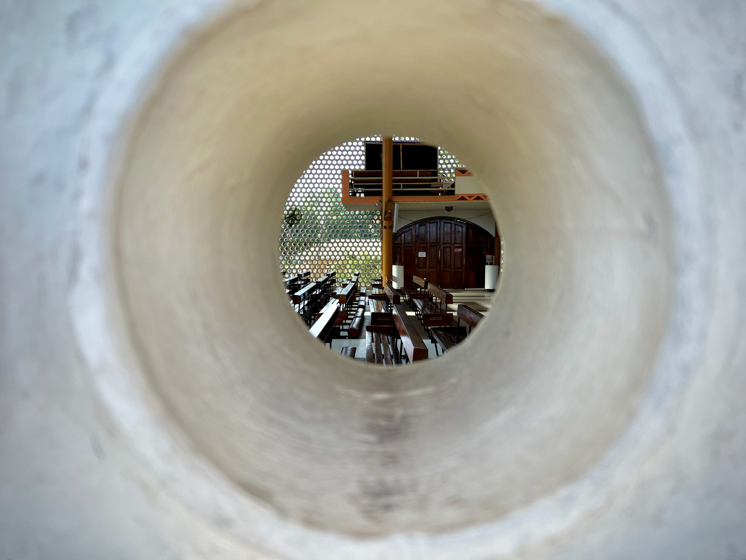 Glimpse of the interior through clay pipe in facade