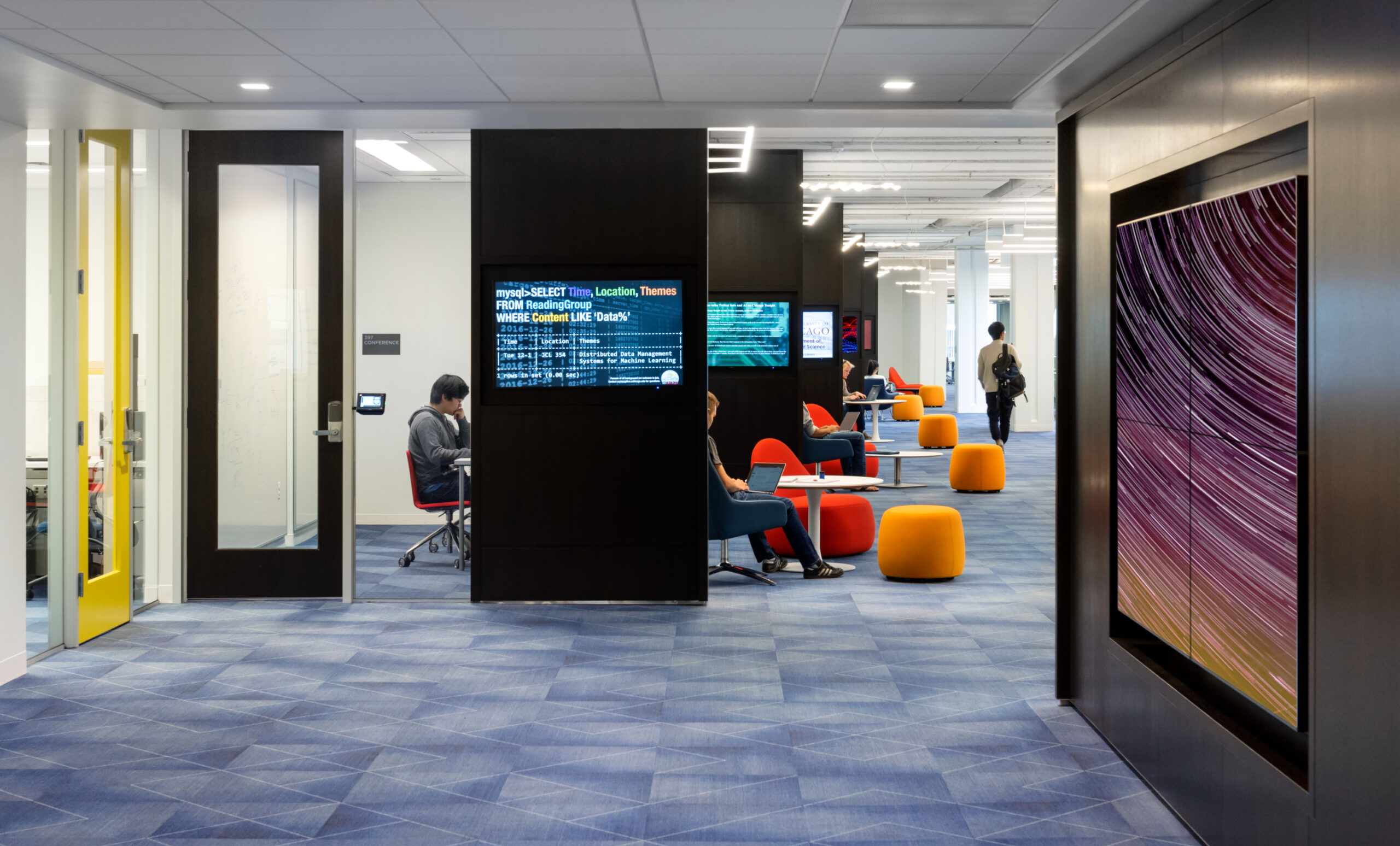 View from reception into the Research Commons, focused on cascading digital displays